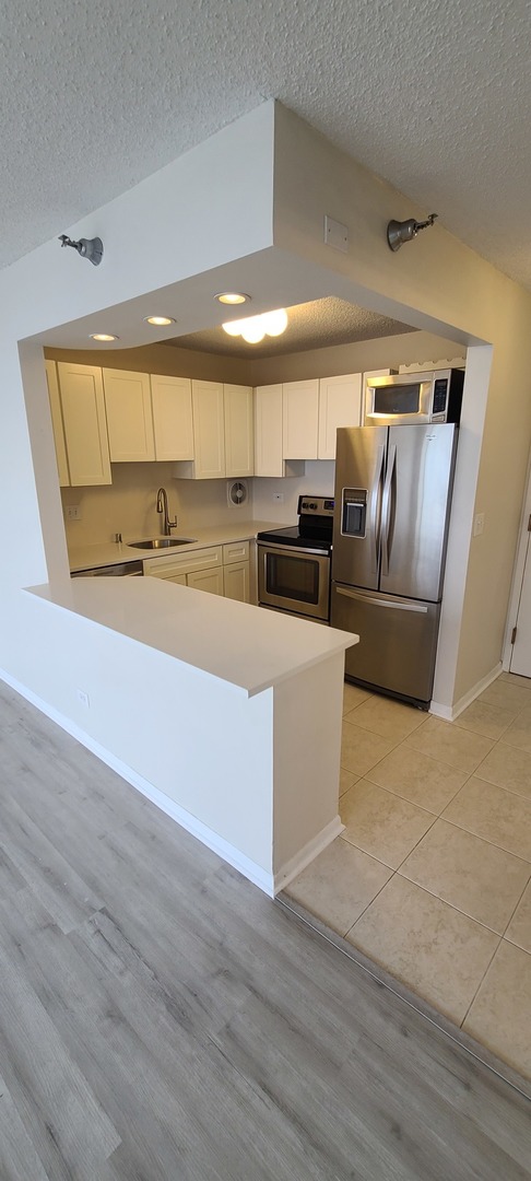 111 West Maple Street, Unit 2309 Chicago, IL 60610 - Photo 5 of 11 a large room with wooden floor