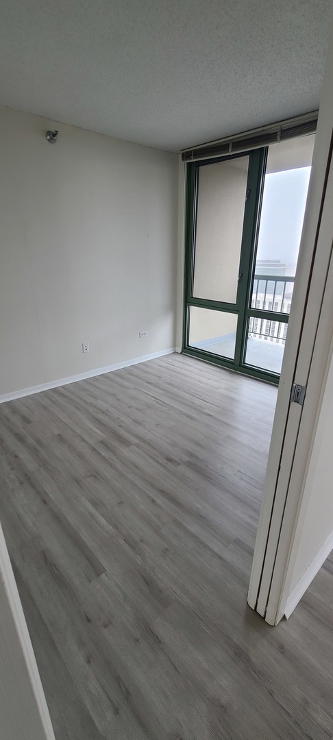 111 West Maple Street, Unit 2309 Chicago, IL 60610 - Photo 7 of 11 a view of an empty room with a window
