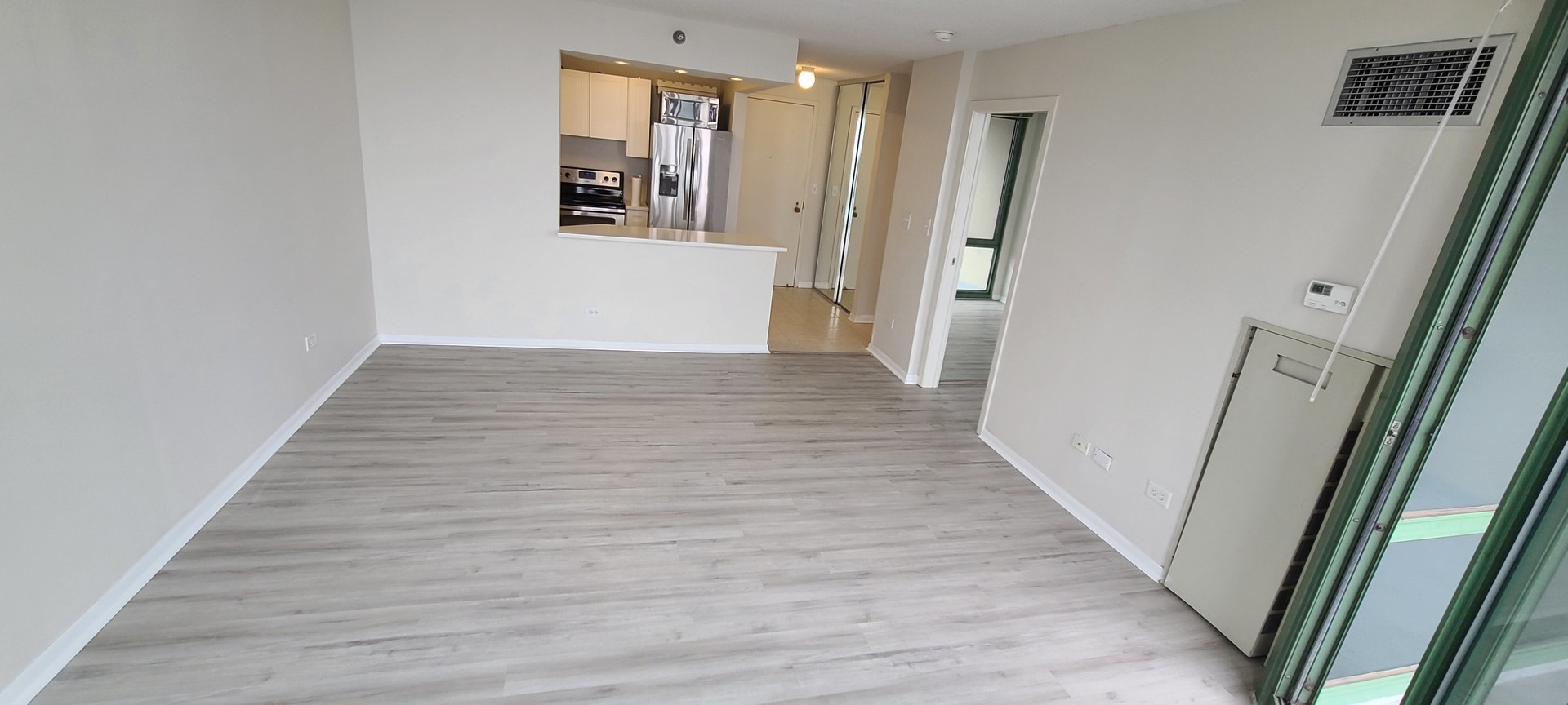 111 West Maple Street, Unit 2309 Chicago, IL 60610 - Photo 8 of 11 a view of a hallway with wooden floor and staircase