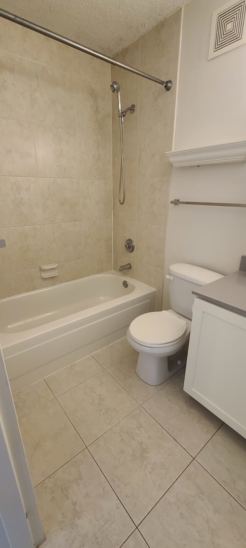 111 West Maple Street, Unit 2309 Chicago, IL 60610 - Photo 9 of 11 a bathroom with a toilet and a shower