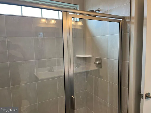 a bathroom with a glass shower door