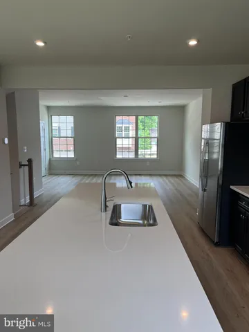 a kitchen with stainless steel appliances granite countertop a sink a stove and a refrigerator