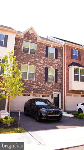 a car parked in front of a brick house