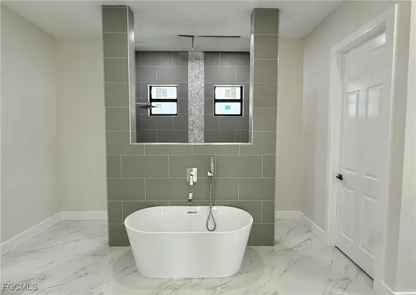 a white bath tub sitting in a bathroom