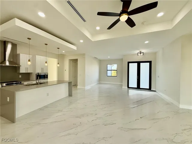 a large space with kitchen view and living room view