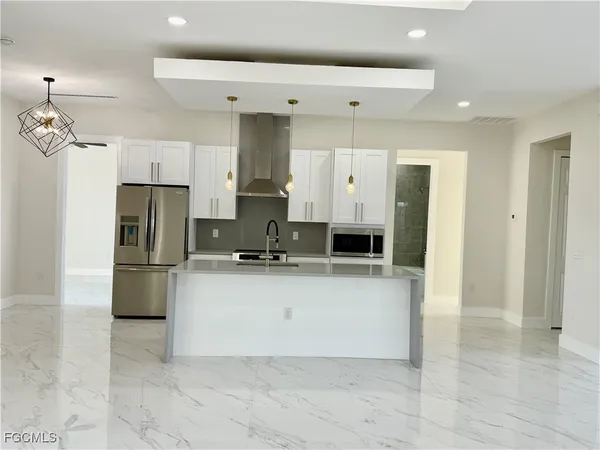 a kitchen with stainless steel appliances a refrigerator sink and stove