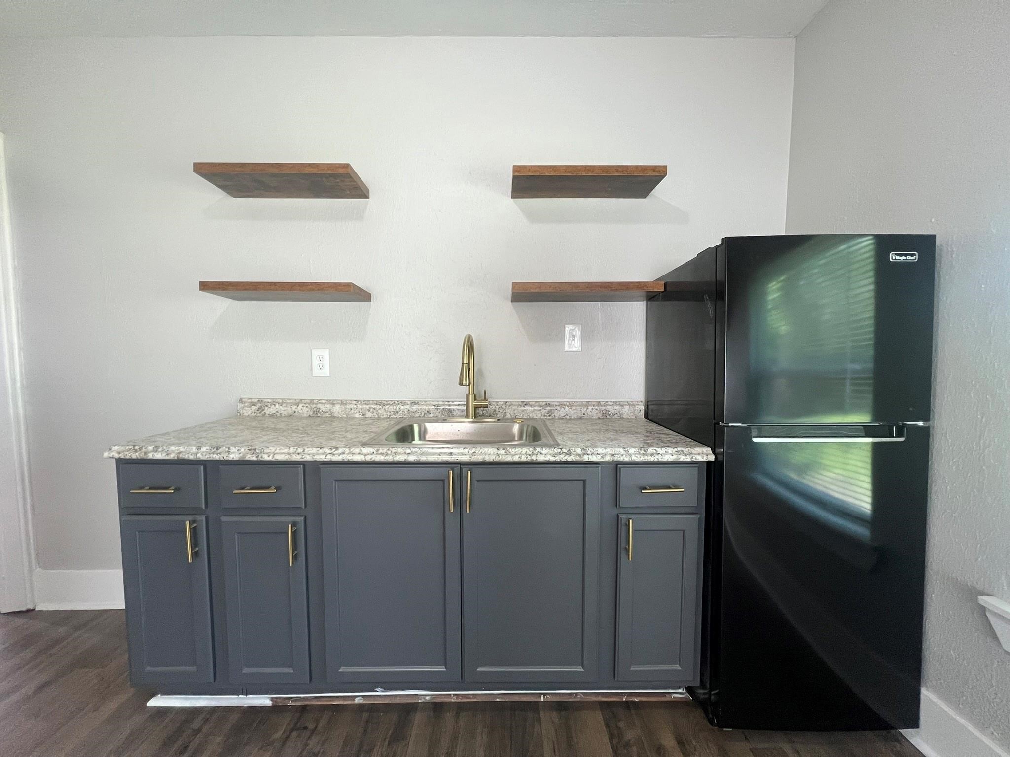2531 Stevens Street Houston, TX 77026 - Photo 11 of 39 a bathroom with a granite countertop sink and mirror