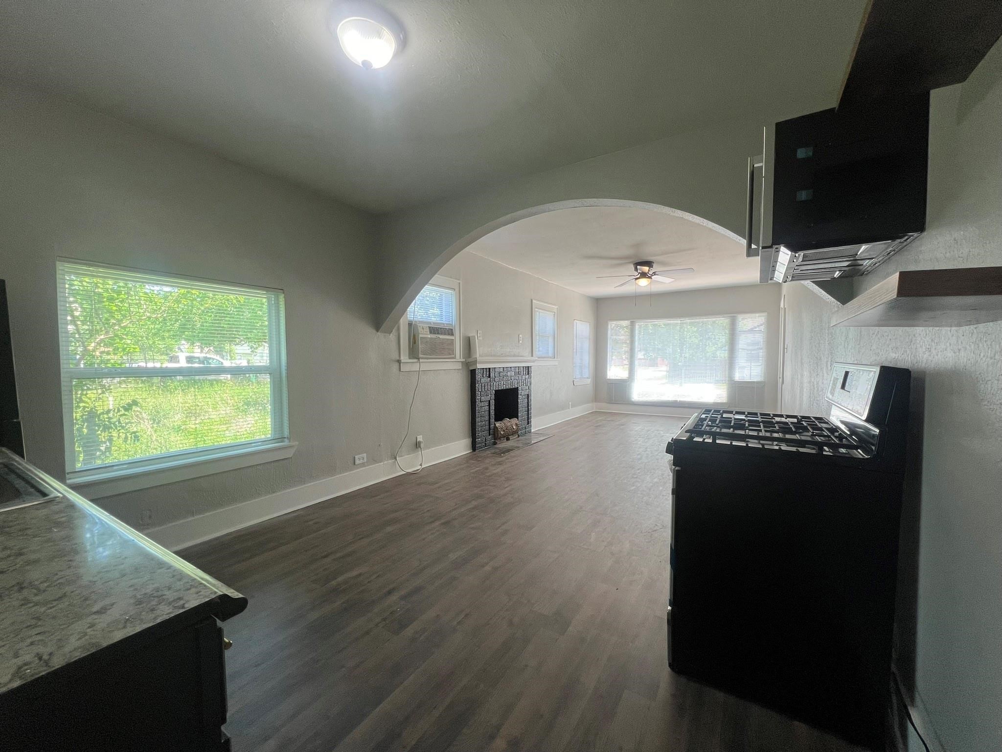 2531 Stevens Street Houston, TX 77026 - Photo 13 of 39 an empty room with wooden floor cabinet and windows
