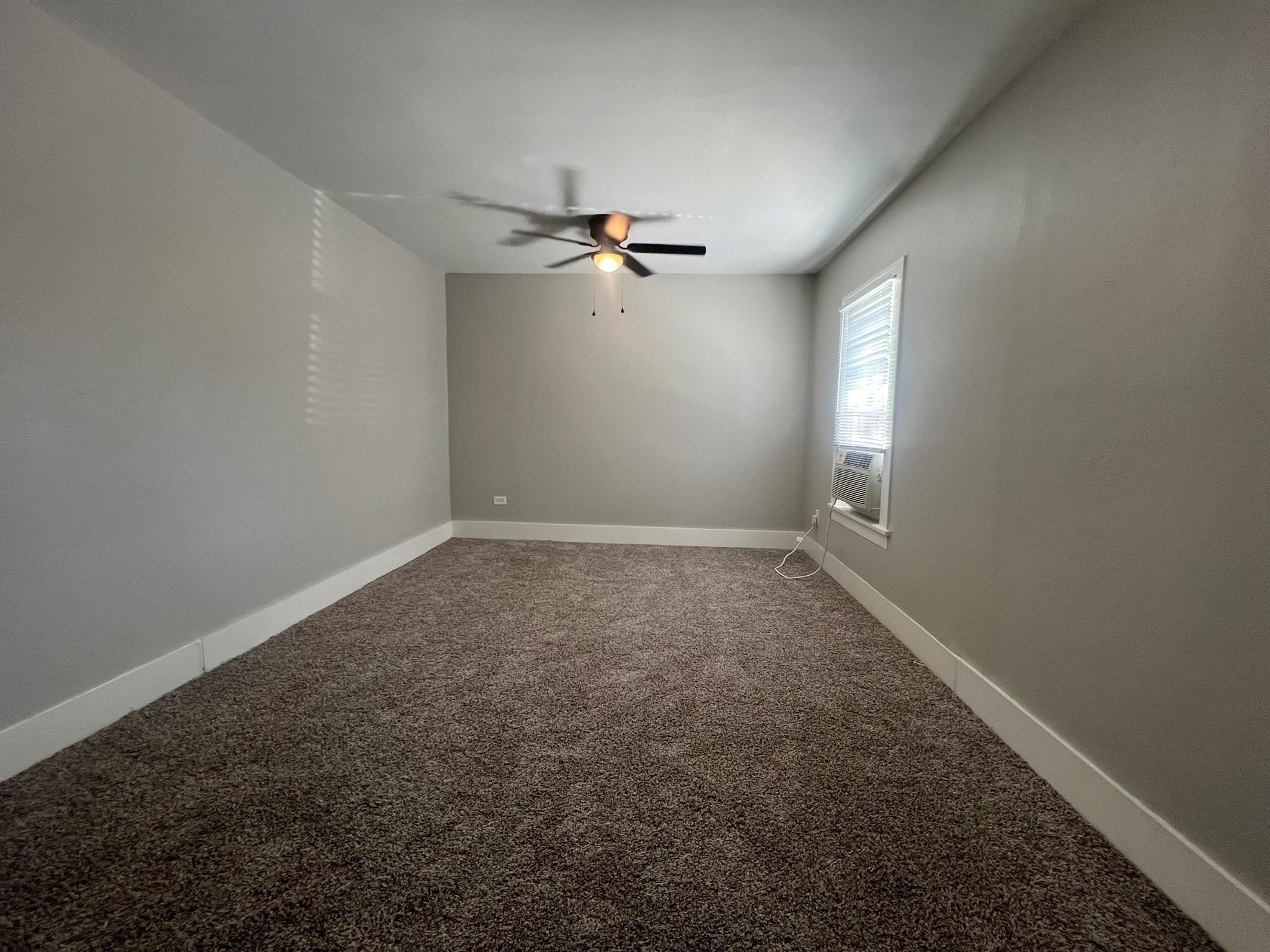 2531 Stevens Street Houston, TX 77026 - Photo 14 of 39 an empty room with a window and a ceiling fan