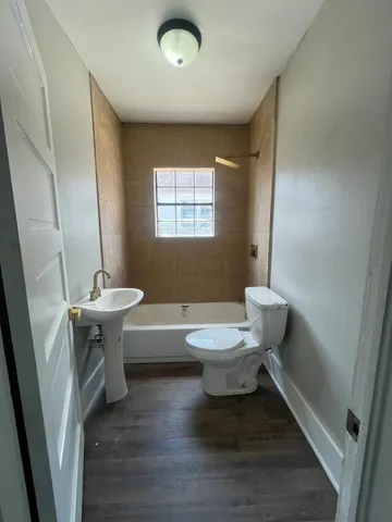 a bathroom with a sink a toilet and tub