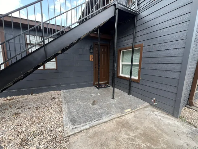 a view of house with wooden stairs and stairs