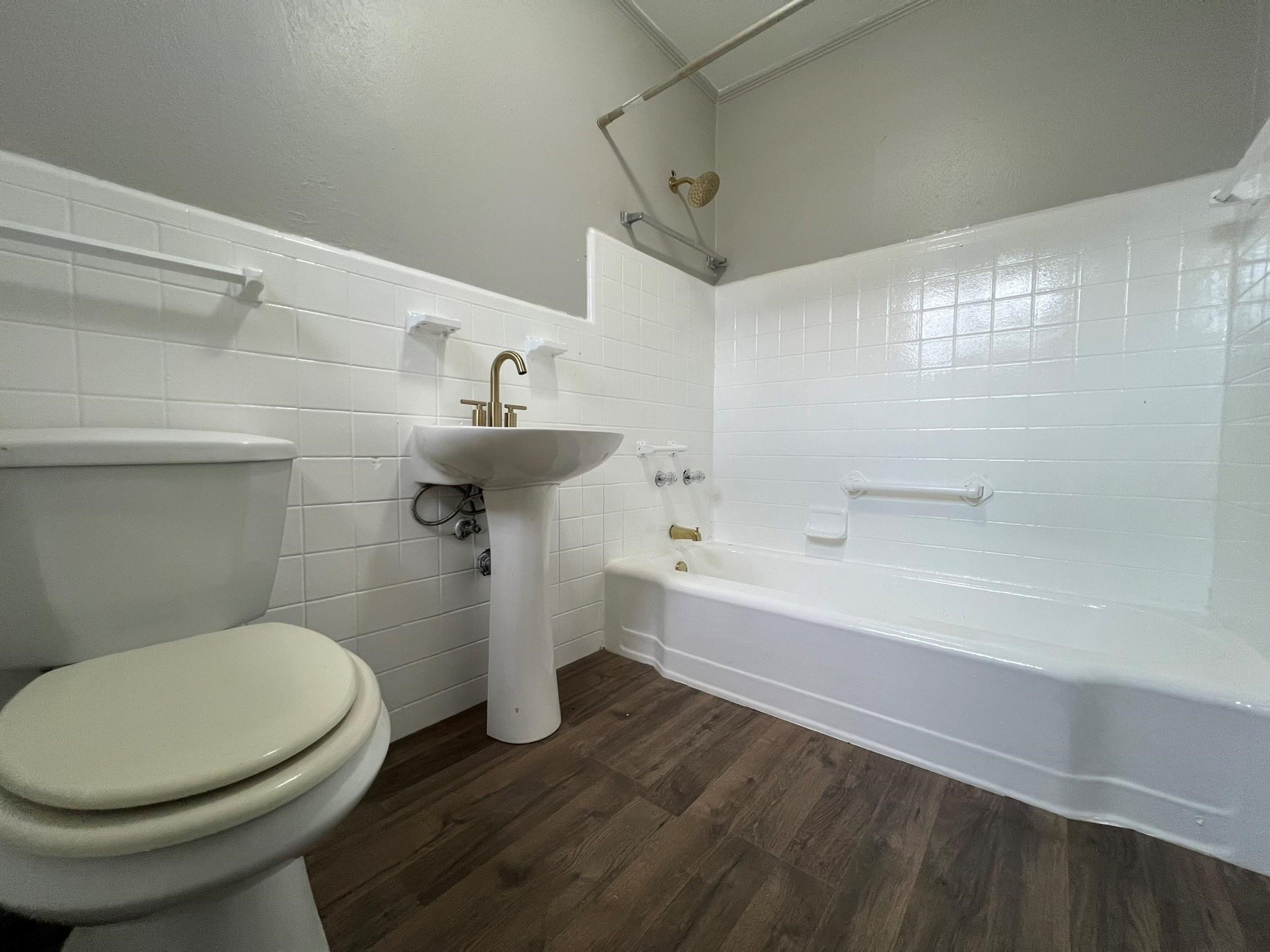 2531 Stevens Street Houston, TX 77026 - Photo 24 of 39 a bathroom with a sink a toilet and bathtub