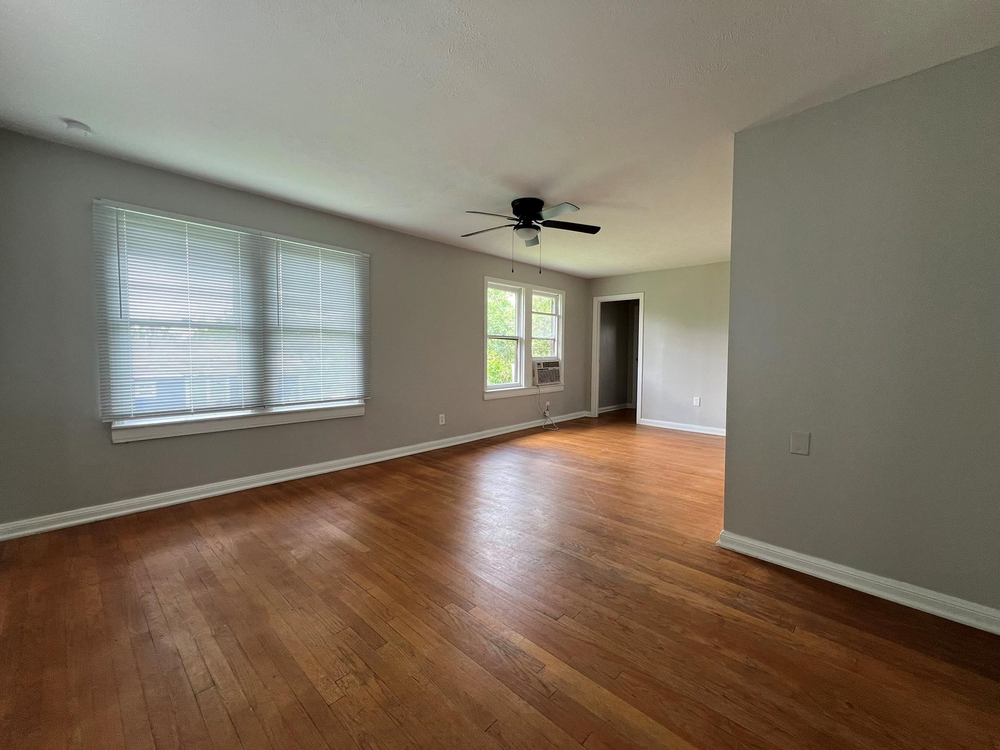 2531 Stevens Street Houston, TX 77026 - Photo 29 of 39 an empty room with wooden floor and windows