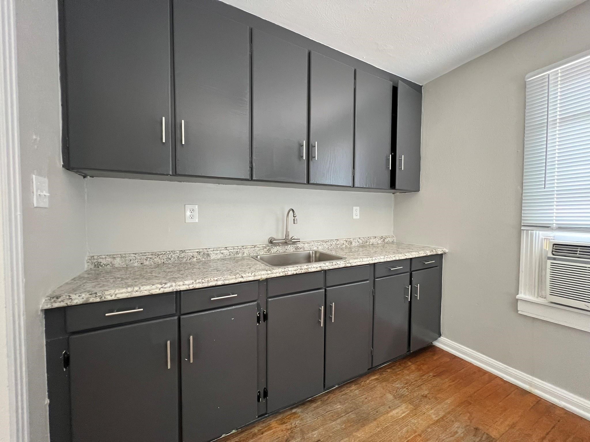 2531 Stevens Street Houston, TX 77026 - Photo 31 of 39 a kitchen with a sink and cabinets