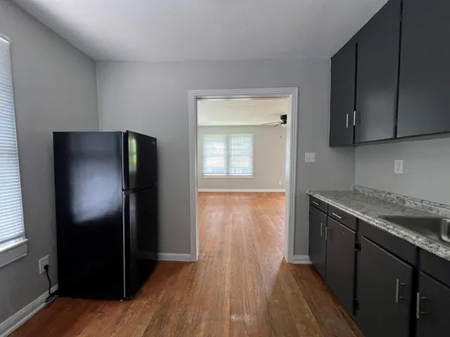 a kitchen with a refrigerator and a sink