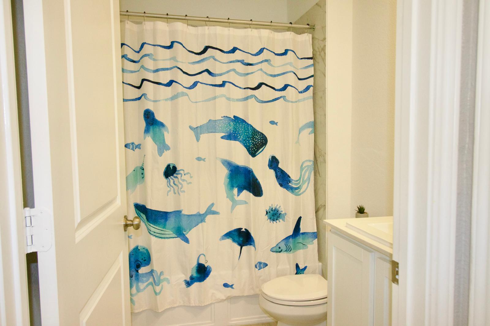 2545 Four Waters Loop Georgetown, TX 78628 - Photo 7 of 14 Crisp white cabinetry paired with a classic vanity setup defines this practical bathroom space.