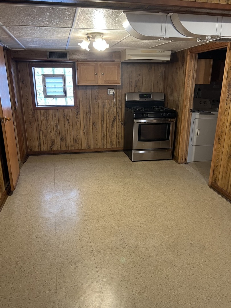 7416 West Addison Street Chicago, IL 60634 - Photo 12 of 19 an empty room with furniture and a fireplace