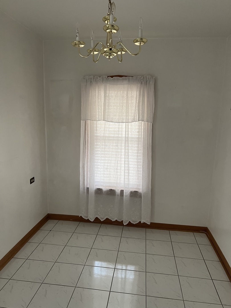 7416 West Addison Street Chicago, IL 60634 - Photo 5 of 19 a view of an empty room with a window