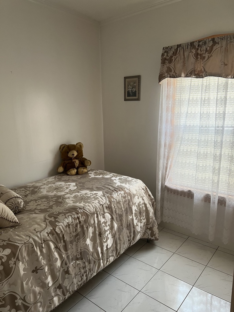 7416 West Addison Street Chicago, IL 60634 - Photo 8 of 19 a bedroom with a bed and a window