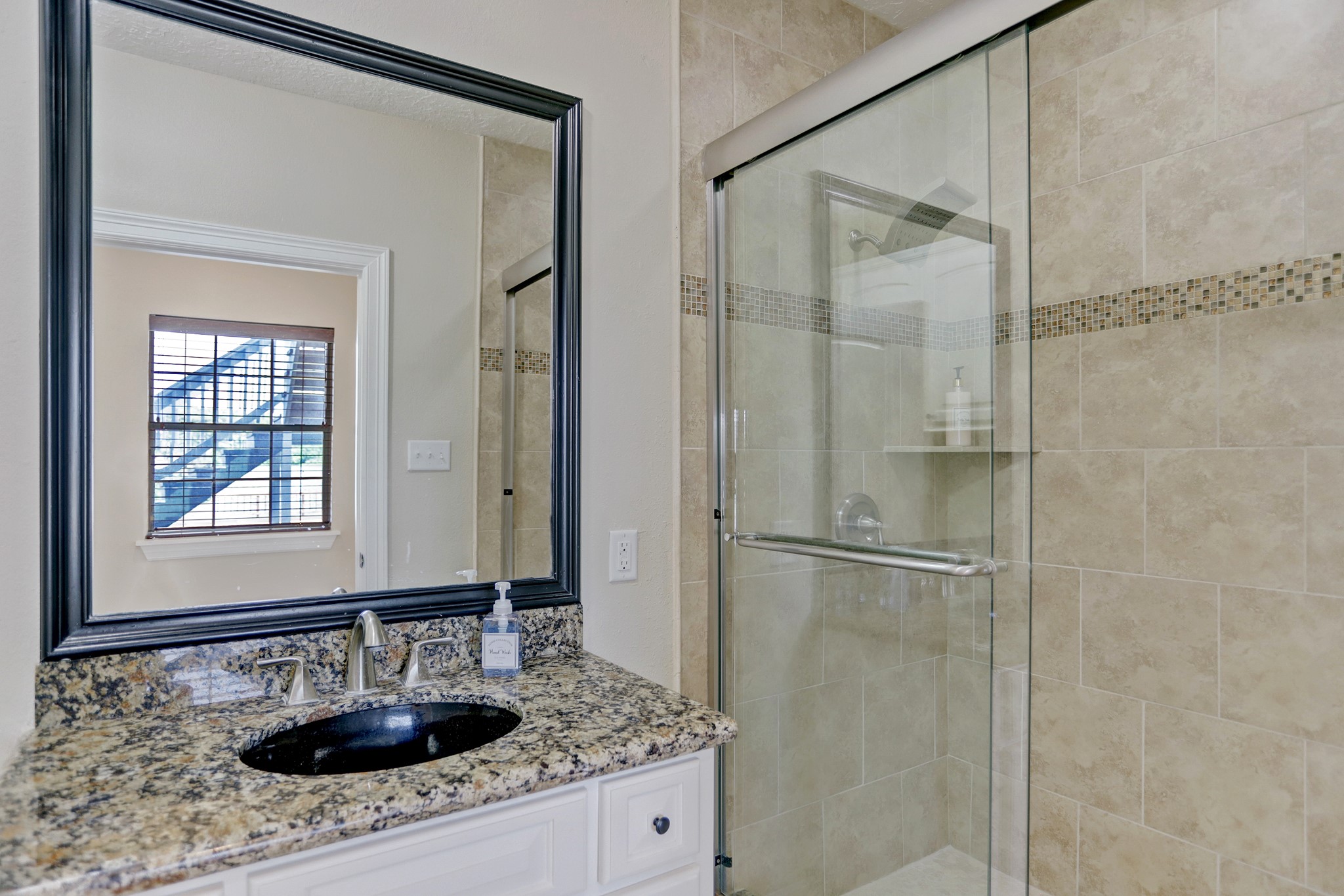 14362 Calvary Road Willis, TX 77318 - Photo 11 of 44 a bathroom with a shower sink and mirror