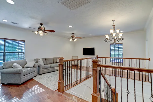 a living room with furniture a chandelier and a window