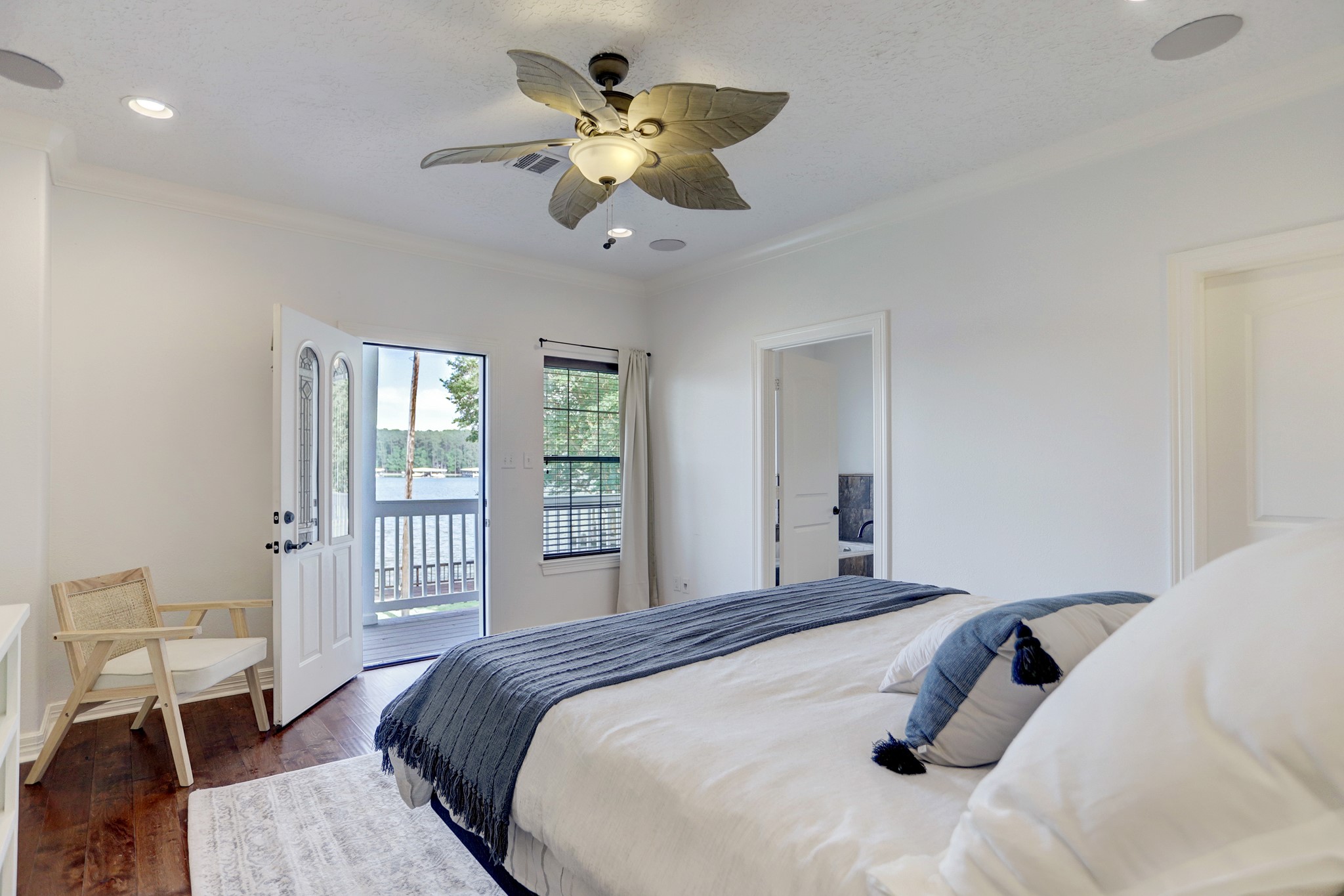14362 Calvary Road Willis, TX 77318 - Photo 17 of 44 a bedroom with a large bed chandelier and a window