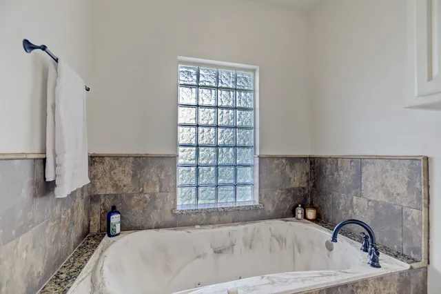 a bathroom with a bathtub and window