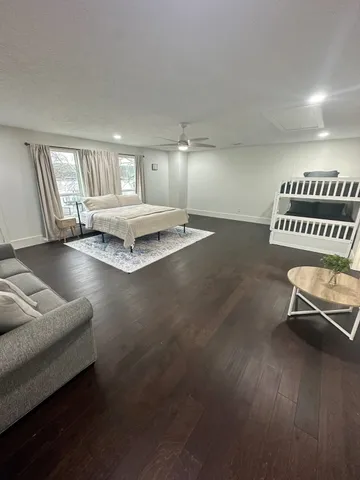 a living room with furniture gym equipment and a window
