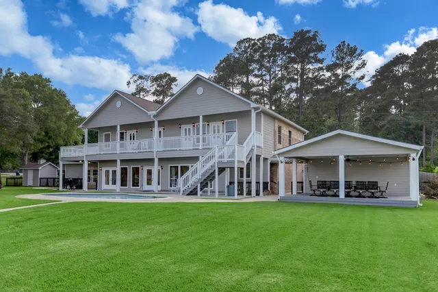 a view of a house with backyard porch and sitting area