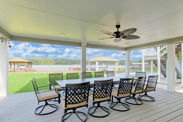 a living room with a table chairs and a floor to ceiling window