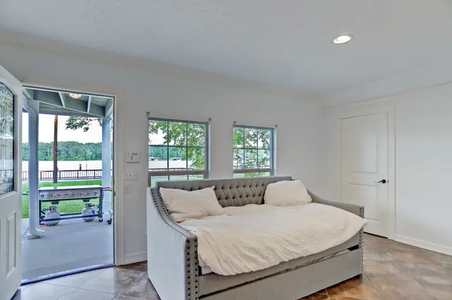 a bedroom with a bed and a chandelier