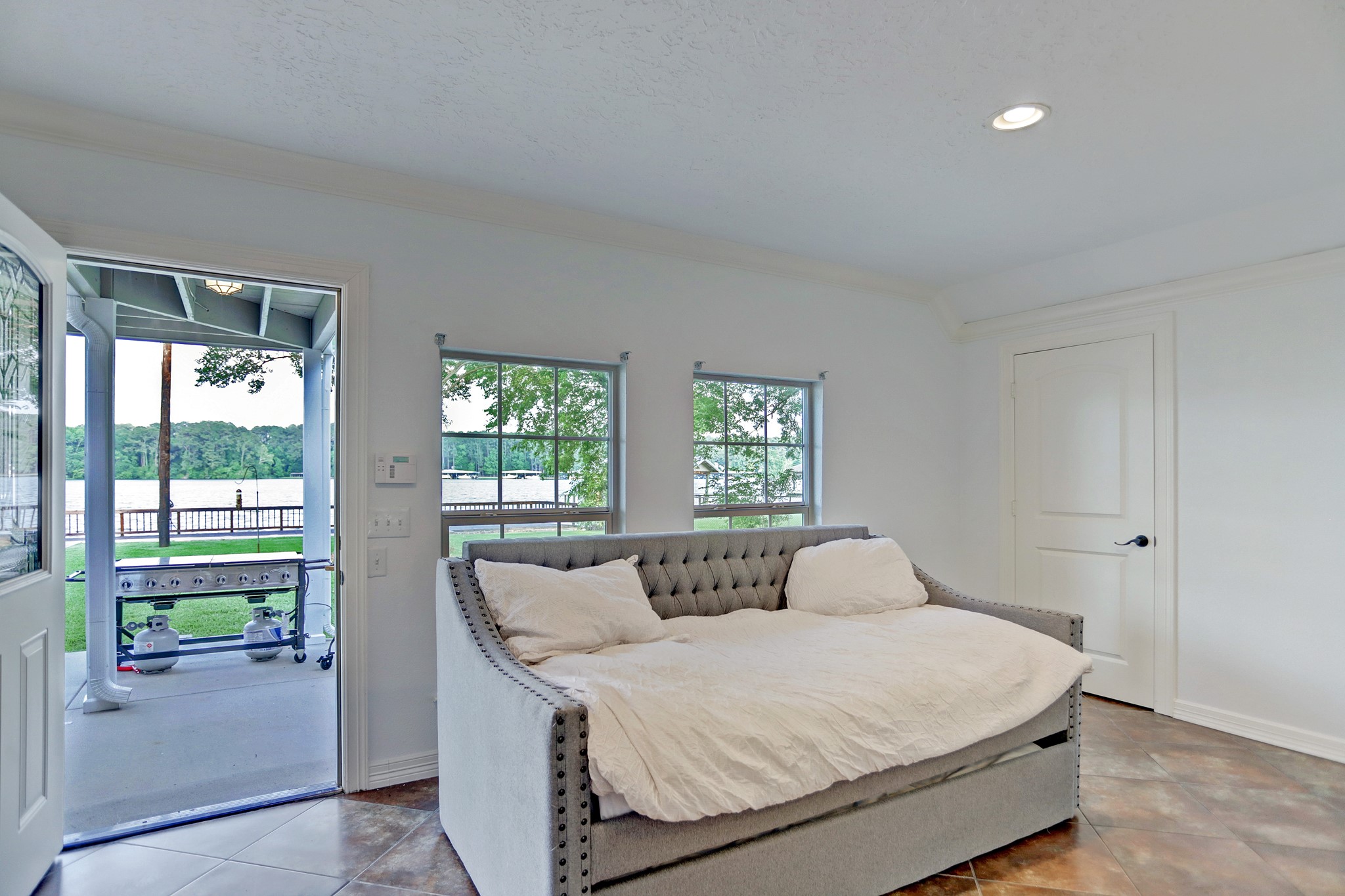 14362 Calvary Road Willis, TX 77318 - Photo 38 of 44 a bedroom with a bed and glass door