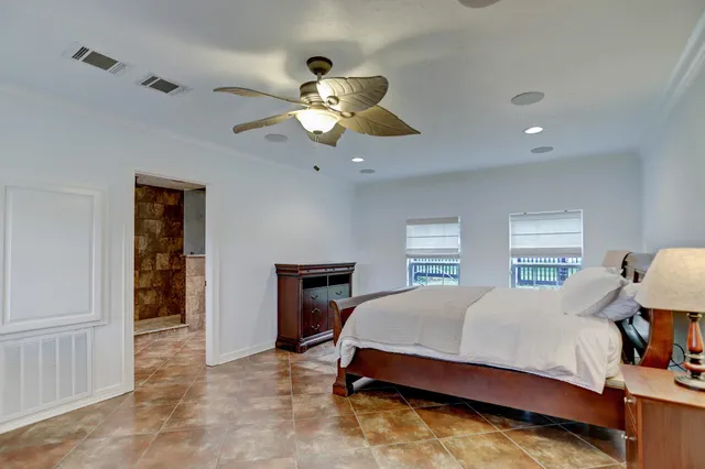 a bathroom with a granite countertop sink a mirror and shower