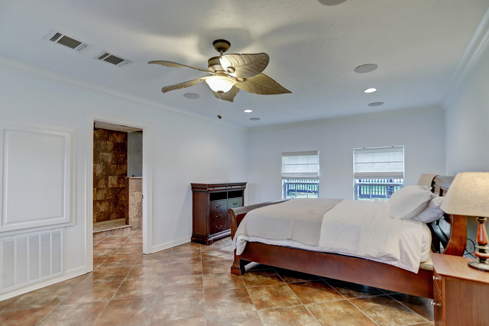 14362 Calvary Road Willis, TX 77318 - Photo 39 of 44 a bedroom with a bed and a chandelier