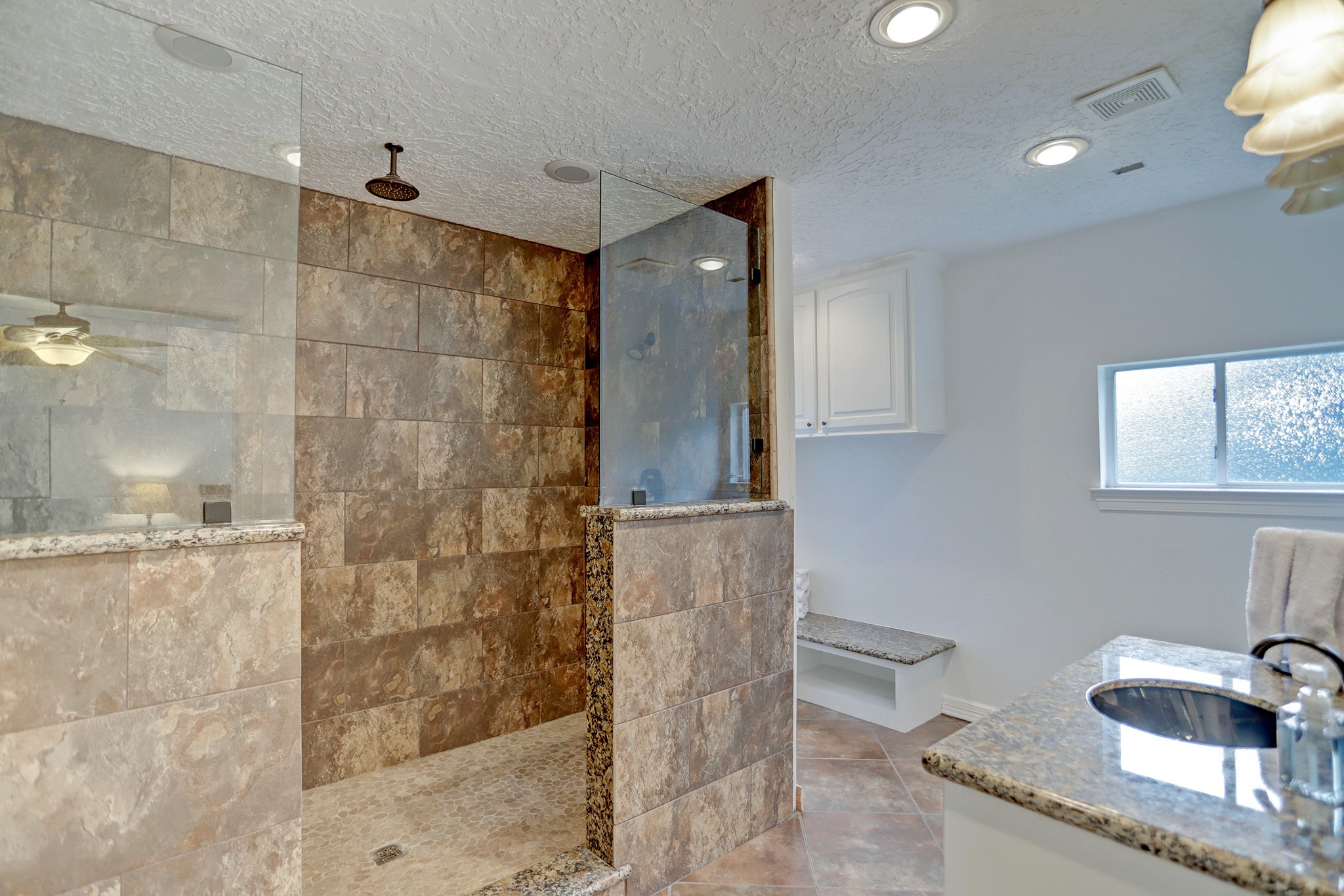 14362 Calvary Road Willis, TX 77318 - Photo 40 of 44 a bathroom with a granite countertop sink a mirror and shower