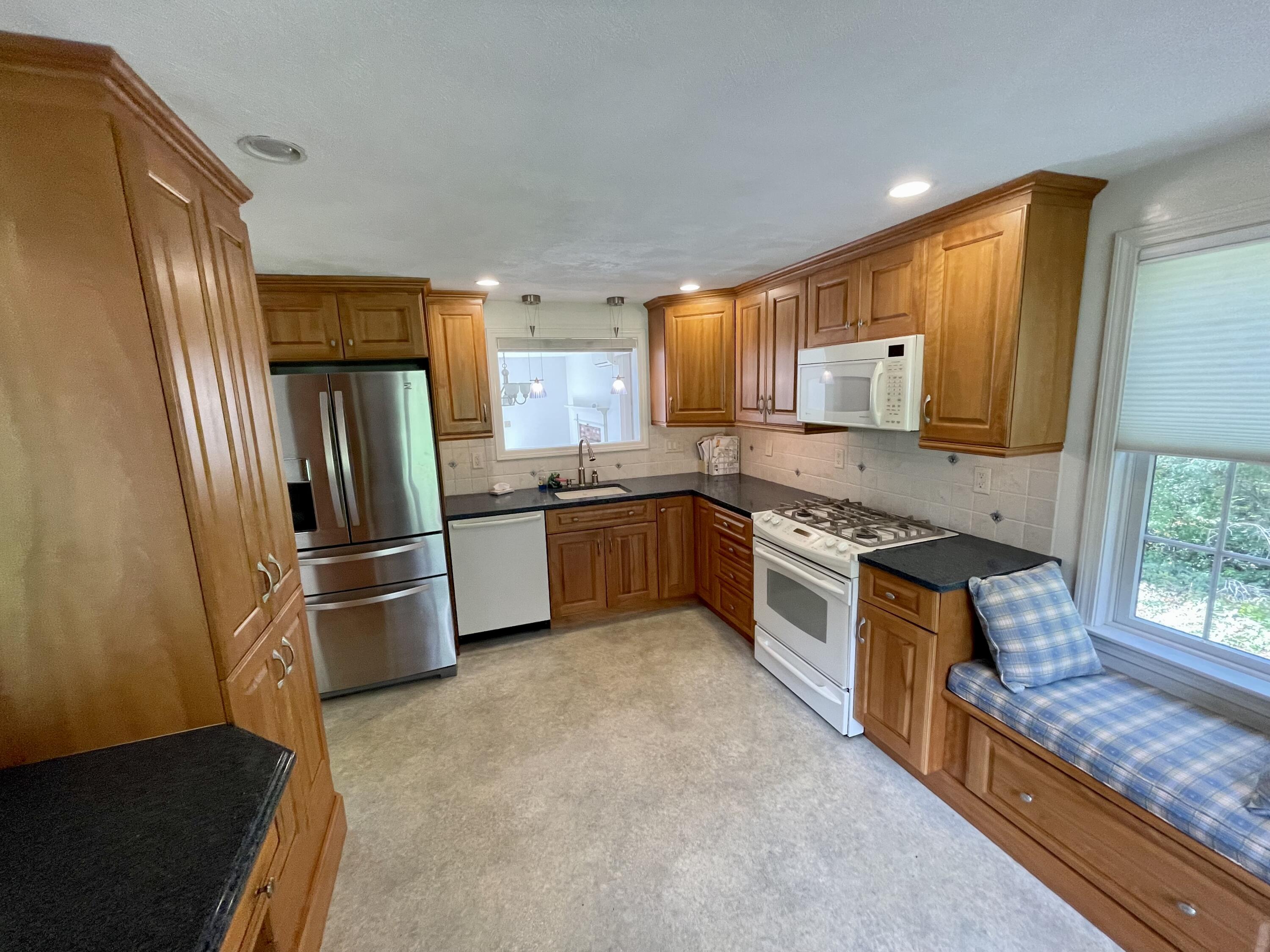 1 Calico Circle, Unit 1 Dennis, MA 02639 - Photo 20 of 52 a large kitchen with stainless steel appliances granite countertop a stove a sink dishwasher a refrigerator and a microwave oven