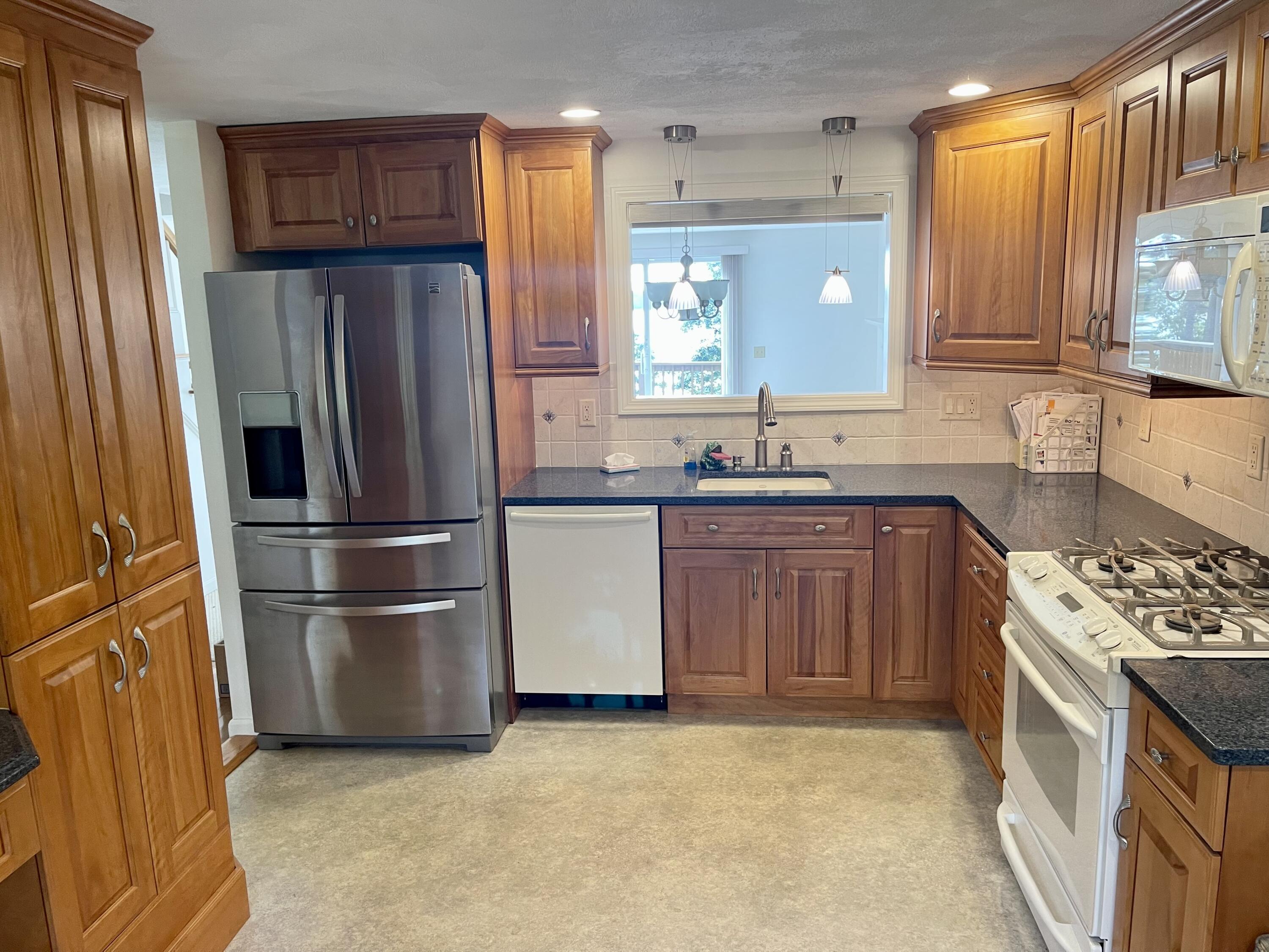 1 Calico Circle, Unit 1 Dennis, MA 02639 - Photo 22 of 52 a kitchen with stainless steel appliances granite countertop a refrigerator a sink a stove a microwave and island