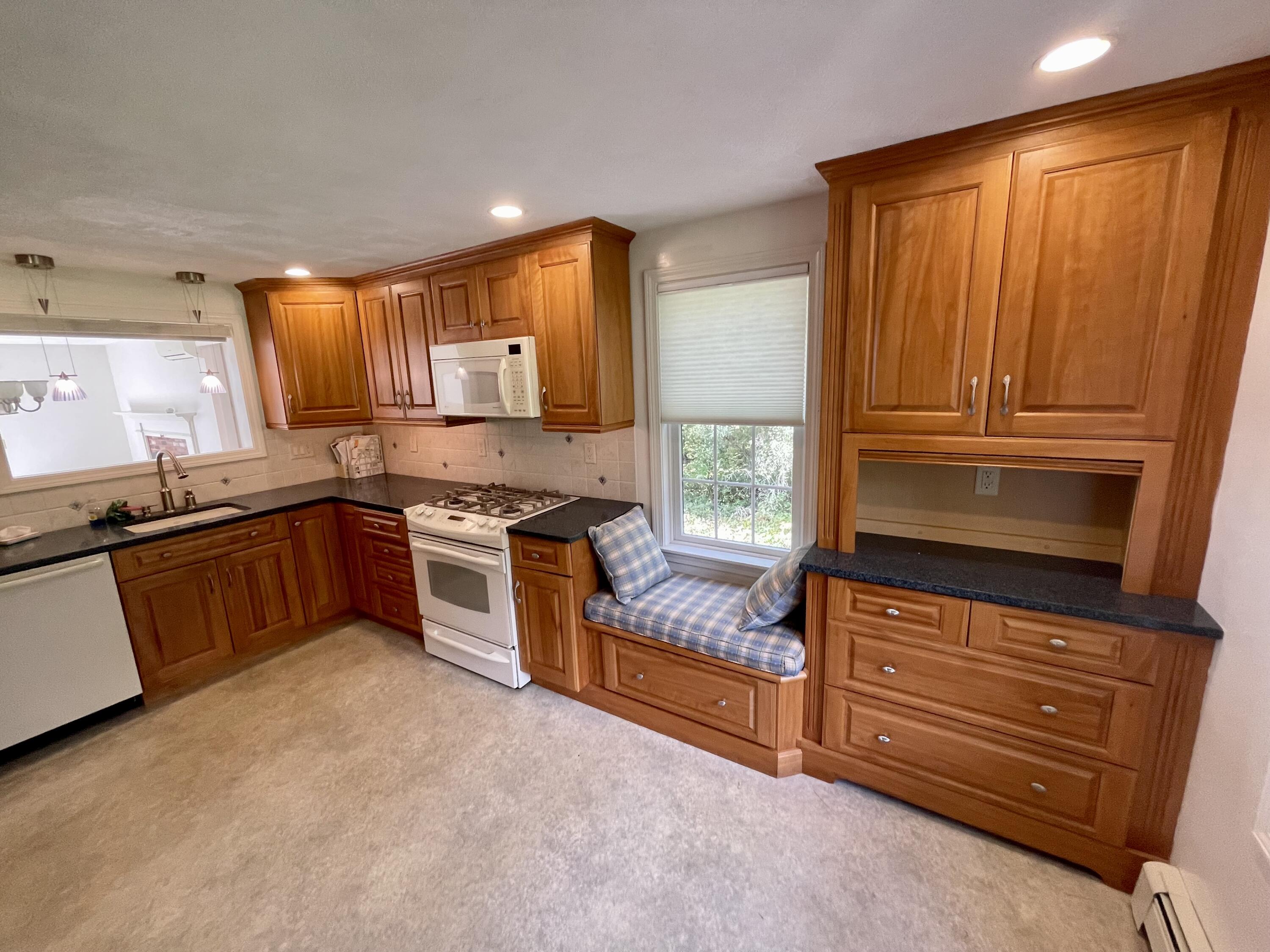 1 Calico Circle, Unit 1 Dennis, MA 02639 - Photo 24 of 52 a kitchen with granite countertop wooden cabinets stainless steel appliances and a window