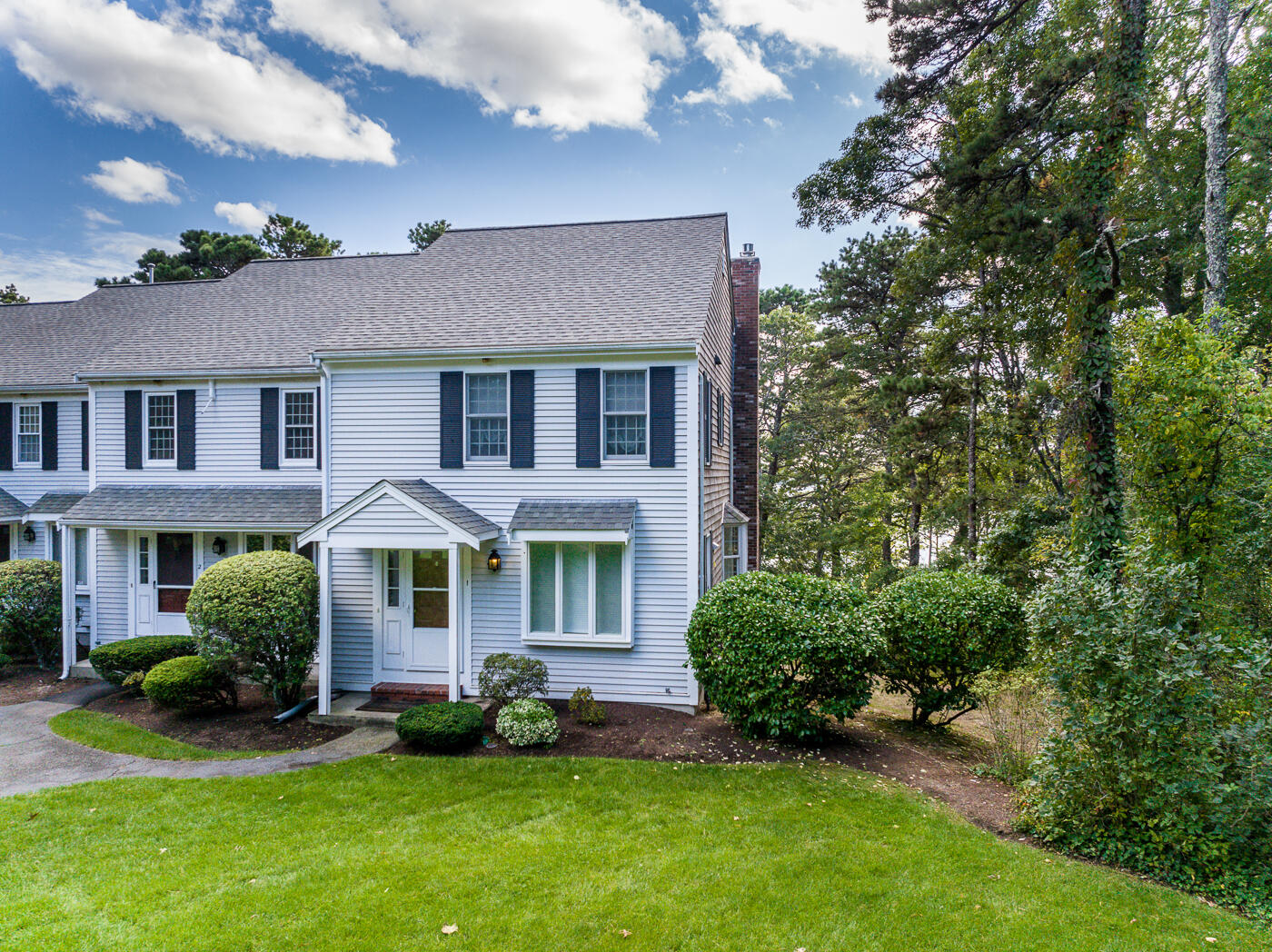 1 Calico Circle, Unit 1 Dennis, MA 02639 - Photo 3 of 52 a front view of a house with a yard