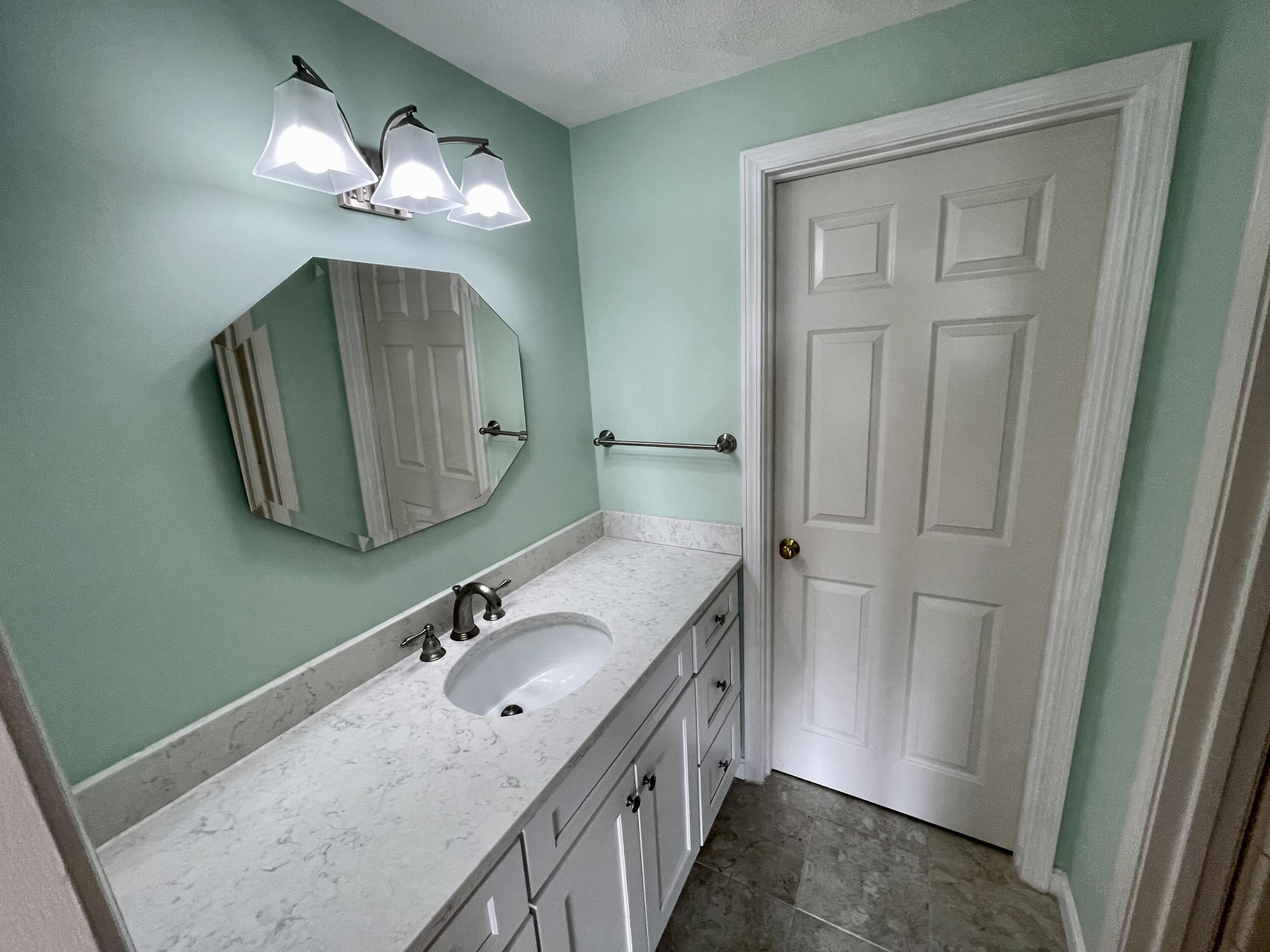 1 Calico Circle, Unit 1 Dennis, MA 02639 - Photo 38 of 52 a bathroom with a sink and a mirror