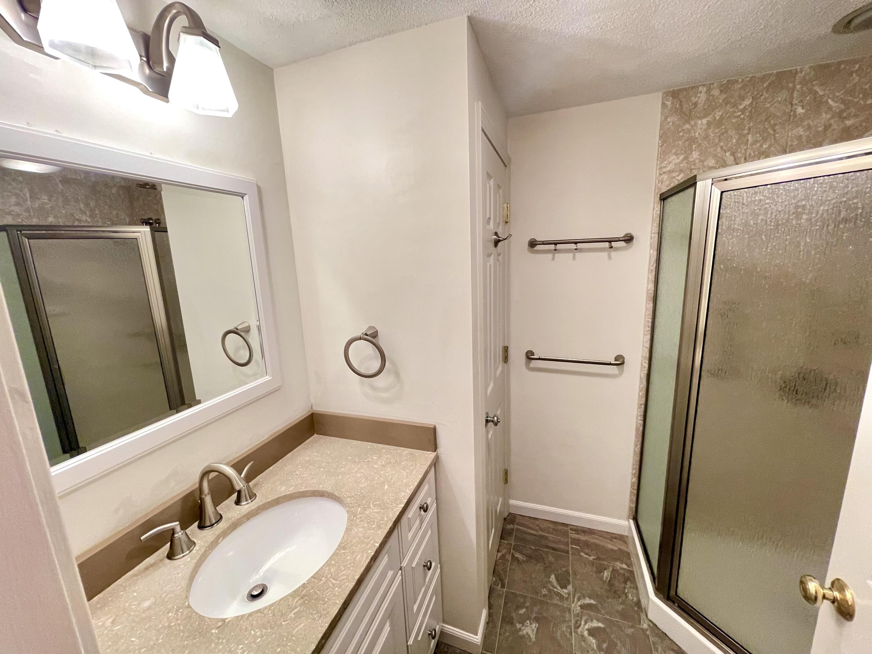 1 Calico Circle, Unit 1 Dennis, MA 02639 - Photo 46 of 52 a bathroom with a granite countertop sink toilet a mirror and shower