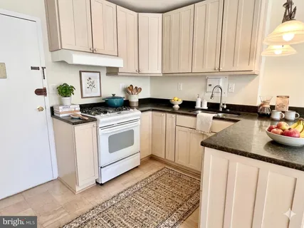 a white refrigerator freezer sitting next to a white cabinet