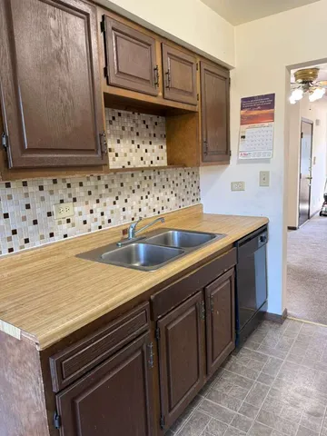 a kitchen with granite countertop a sink and a stove