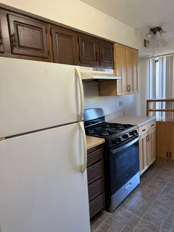 a kitchen with stainless steel appliances a refrigerator and a stove top oven