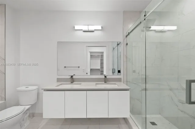 a bedroom with furniture and a large window