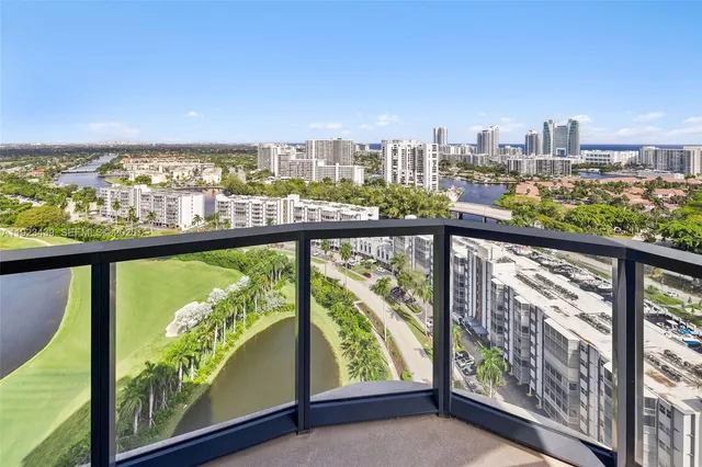 a kitchen with a sink dishwasher a stove and a microwave oven with wooden floor