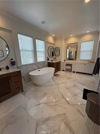 a spacious bathroom with a toilet sink and mirror