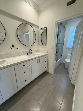 a bathroom with a double vanity sink and a mirror
