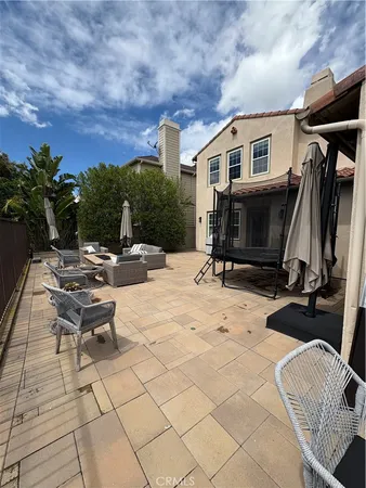 a view of roof deck with table and chairs a barbeque with potted plants