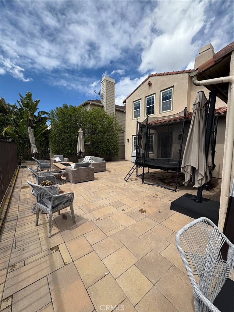 72 Downing Street Ladera Ranch, CA 92694 - Photo 16 of 24 a view of roof deck with table and chairs a barbeque with potted plants